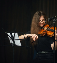 Violin student rehearsing with sheet music